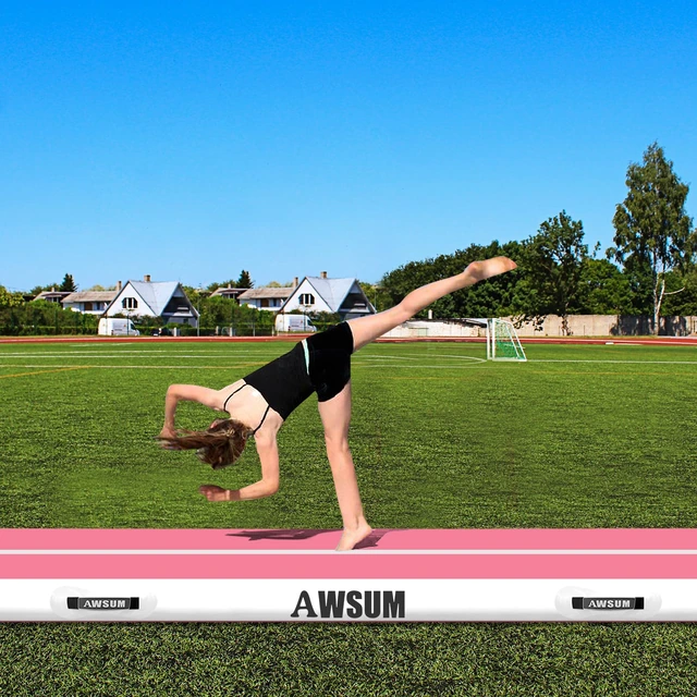 Outdoor gymnastics practice on the pink face of an AWSUM air track